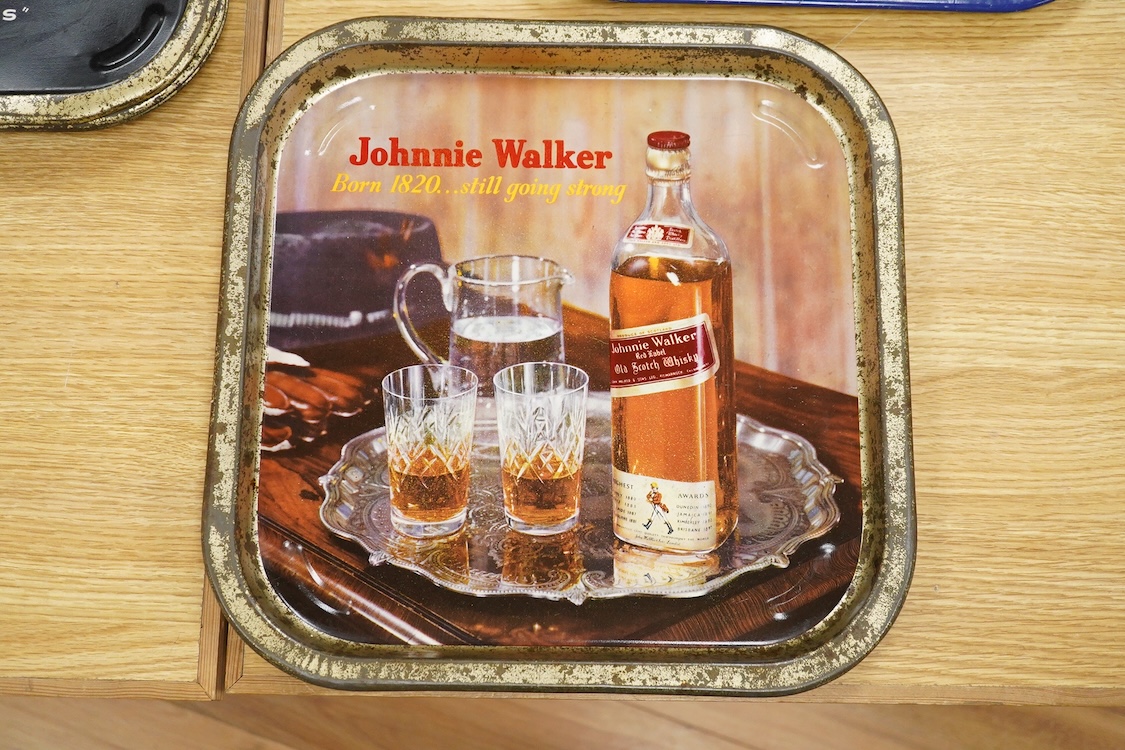 Five 1960s pub advertising trays for Scotch Whisky to include Johnnie Walker and Black & White, Buchanans, 35cm wide